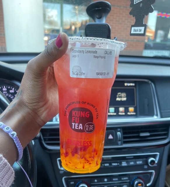 orange Boba drink in the car